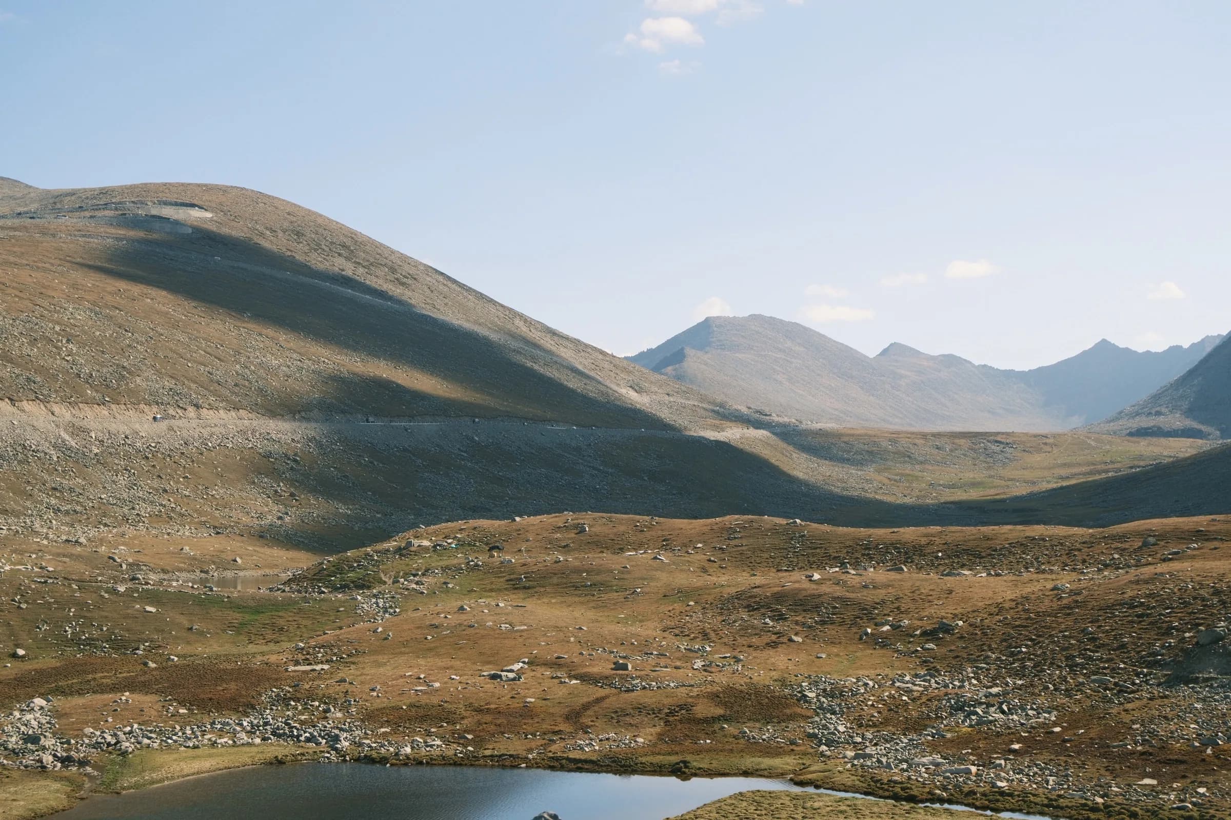 A high mountain pass with small lakes and a winding road