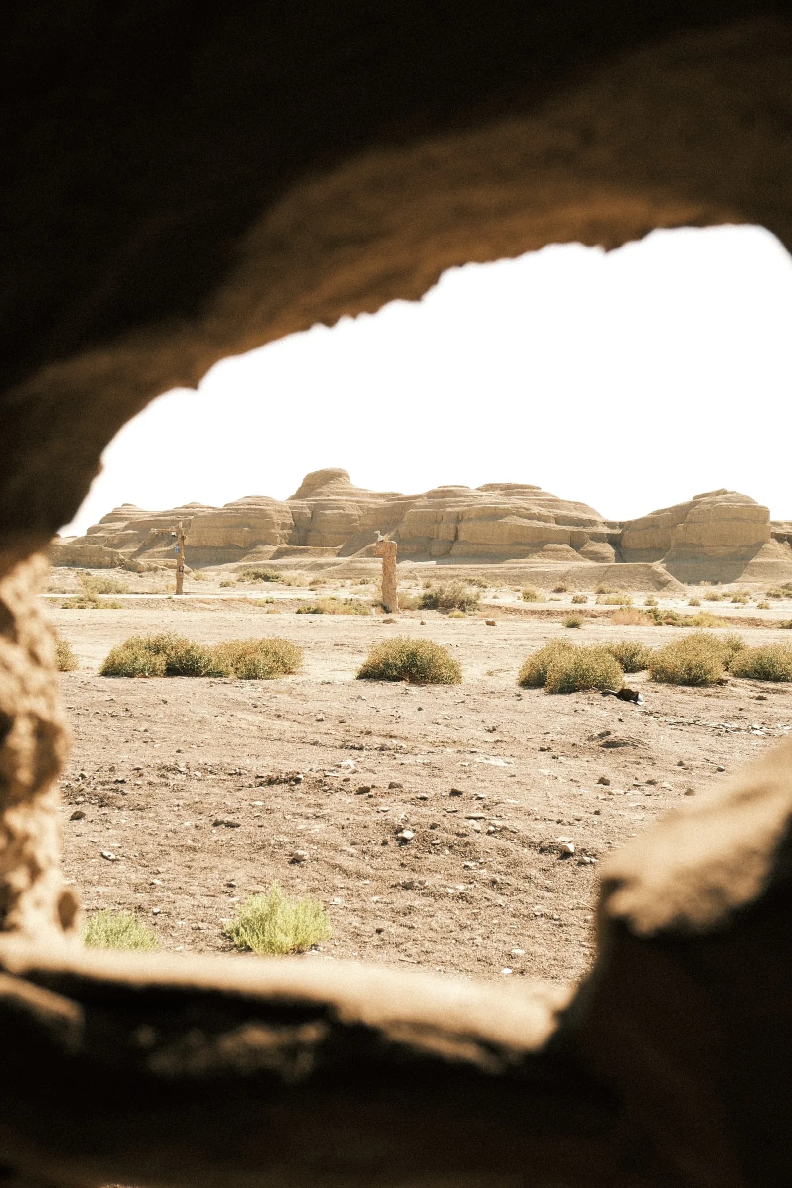 Desert ridges framed by a rough rock opening