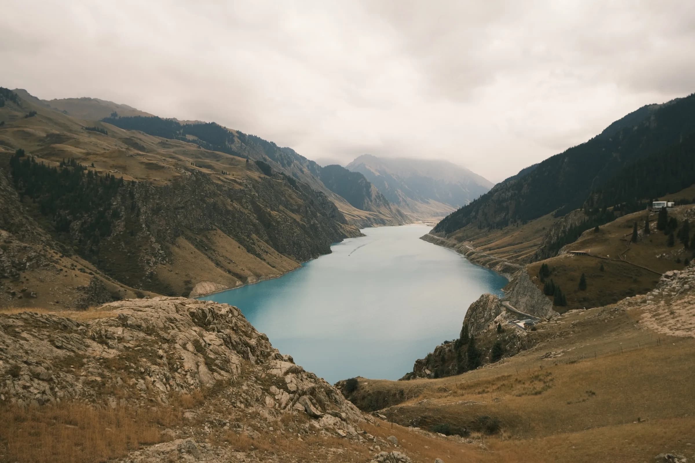 Long blue lake filling a broad mountain valley